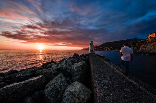 Camogli pier and lighthouse at sunset. Same POV as the image above, but different treatmemtat sunset